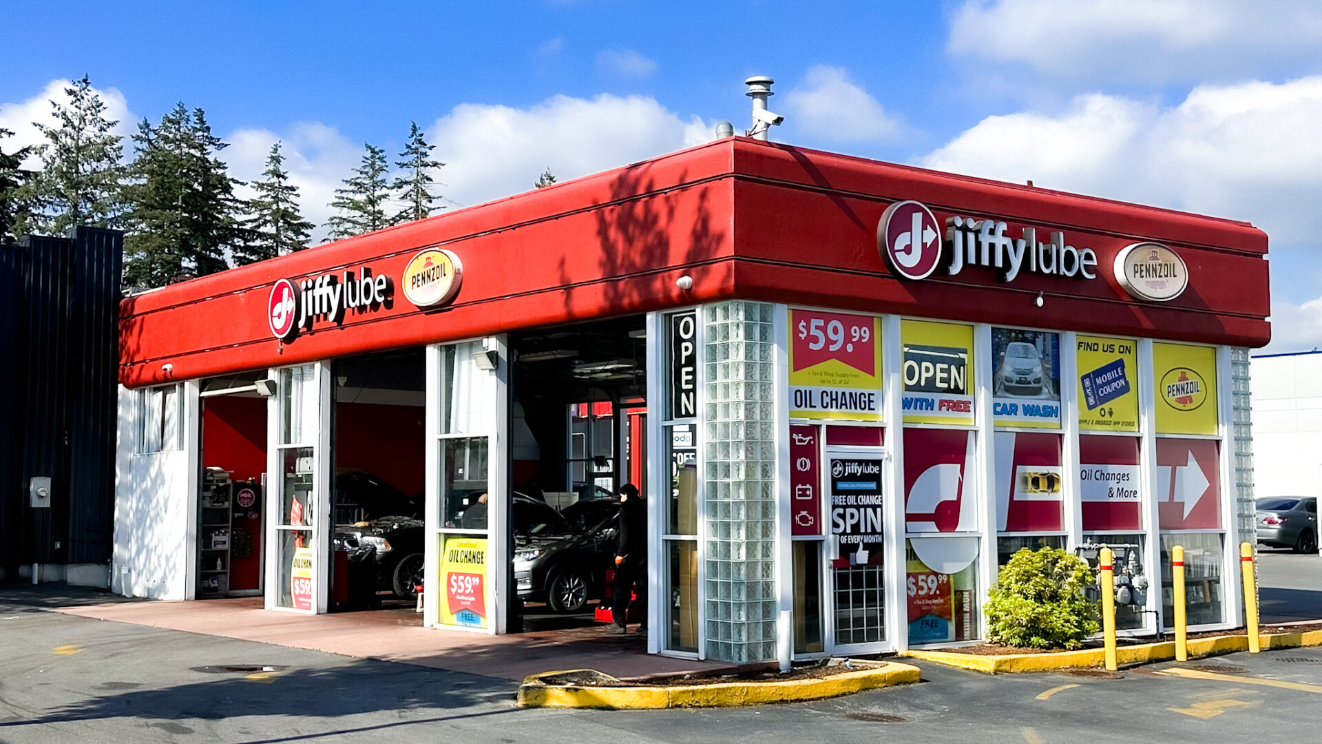 Jiffy Lube Newton storefront in Surrey, BC, with $59.99 oil change signs